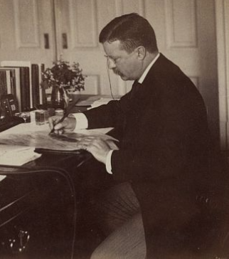 Photo of Theodore Roosevelt writing